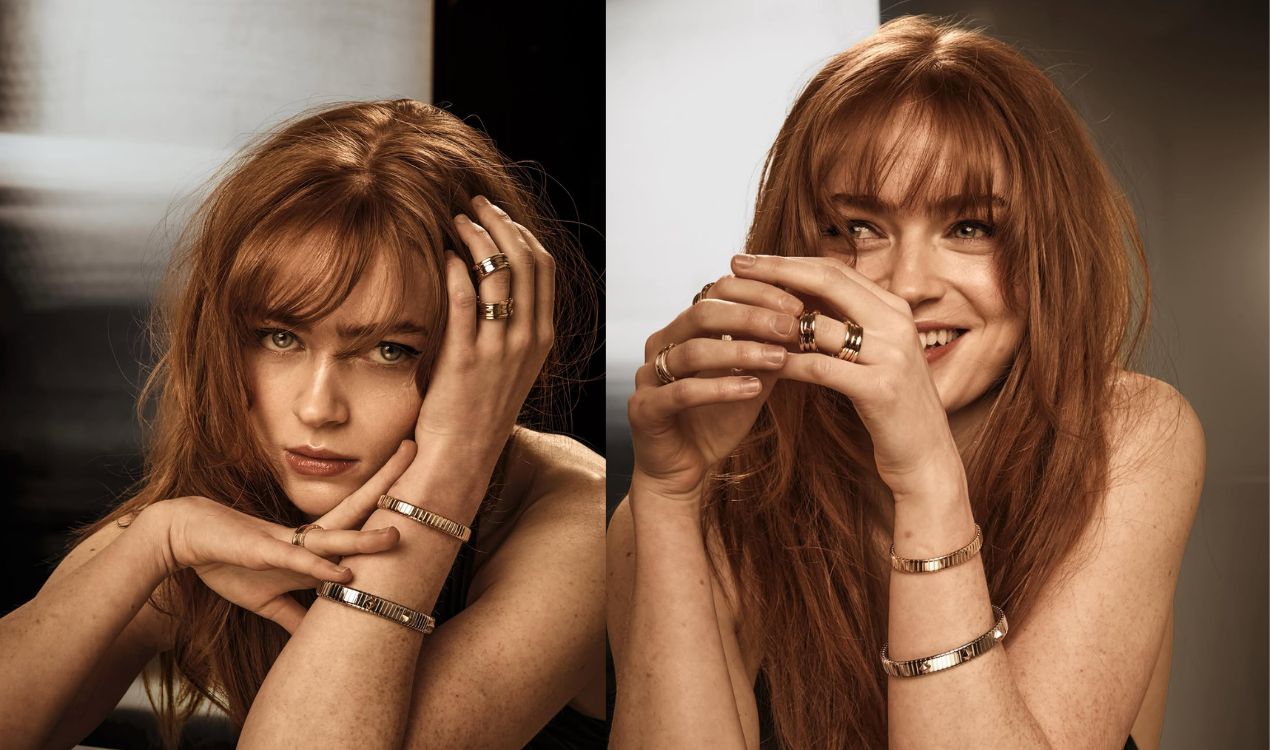 Close up portrait of Sadie Sink posing with bangs hairstyle and wearing elegant gold rings and bracelets